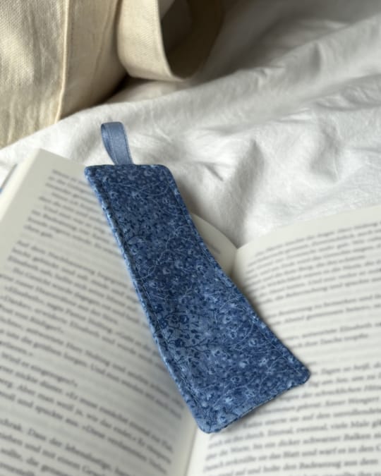 Handmade fabric bookmark placed in a book