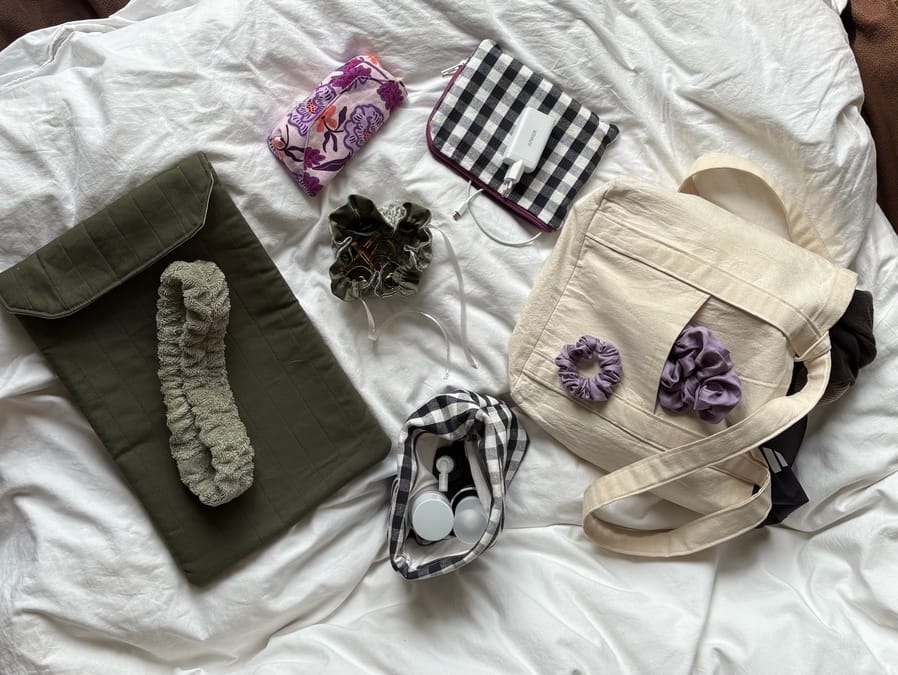 Flat lay of all handmade vacation sewing projects including bags, scrunchies, and accessories