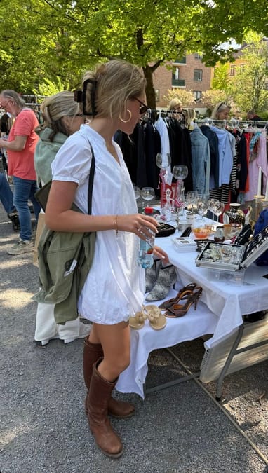 Woman in white dress with brown leather boots